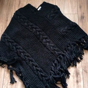 A plus size poncho made by Currency
